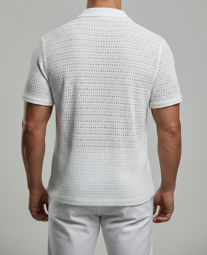 Man wearing a textured white shirt and light gray pants against a plain background
